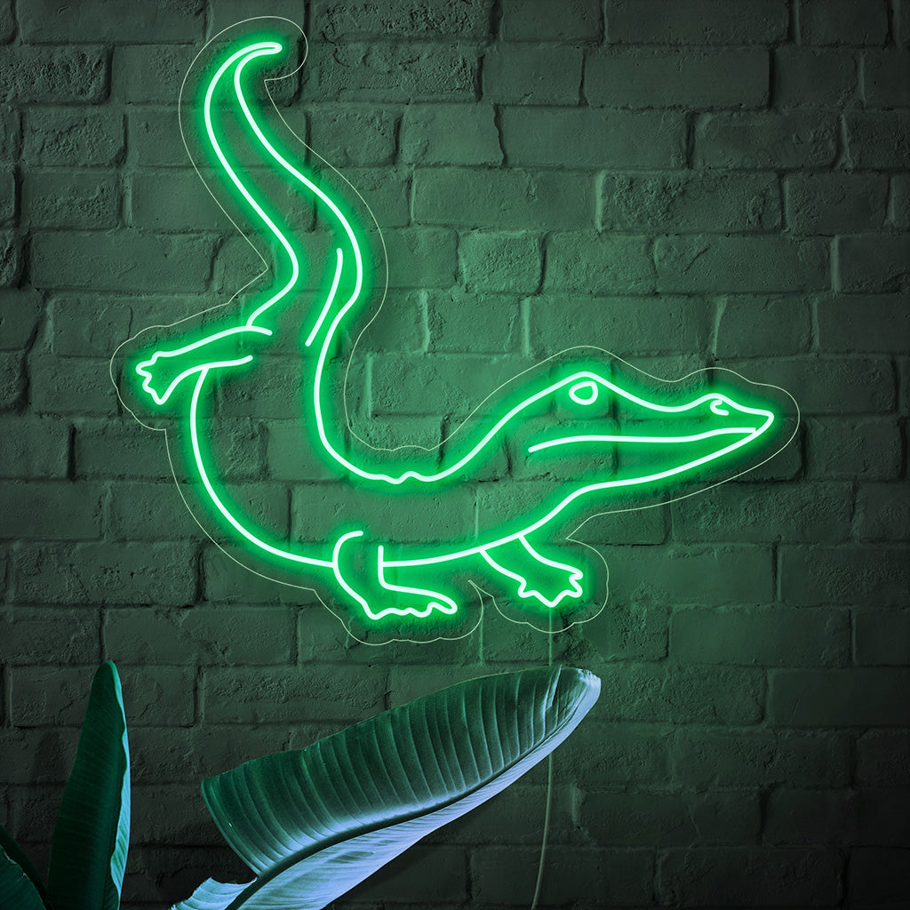 "Crocodile Neon Sign" ��� Rohkea ja eksoottinen neonvalo, joka esittelee krokotiilin siluettia ja lisää tilaan rajua energiaa ja seikkailunhaluista charmia.