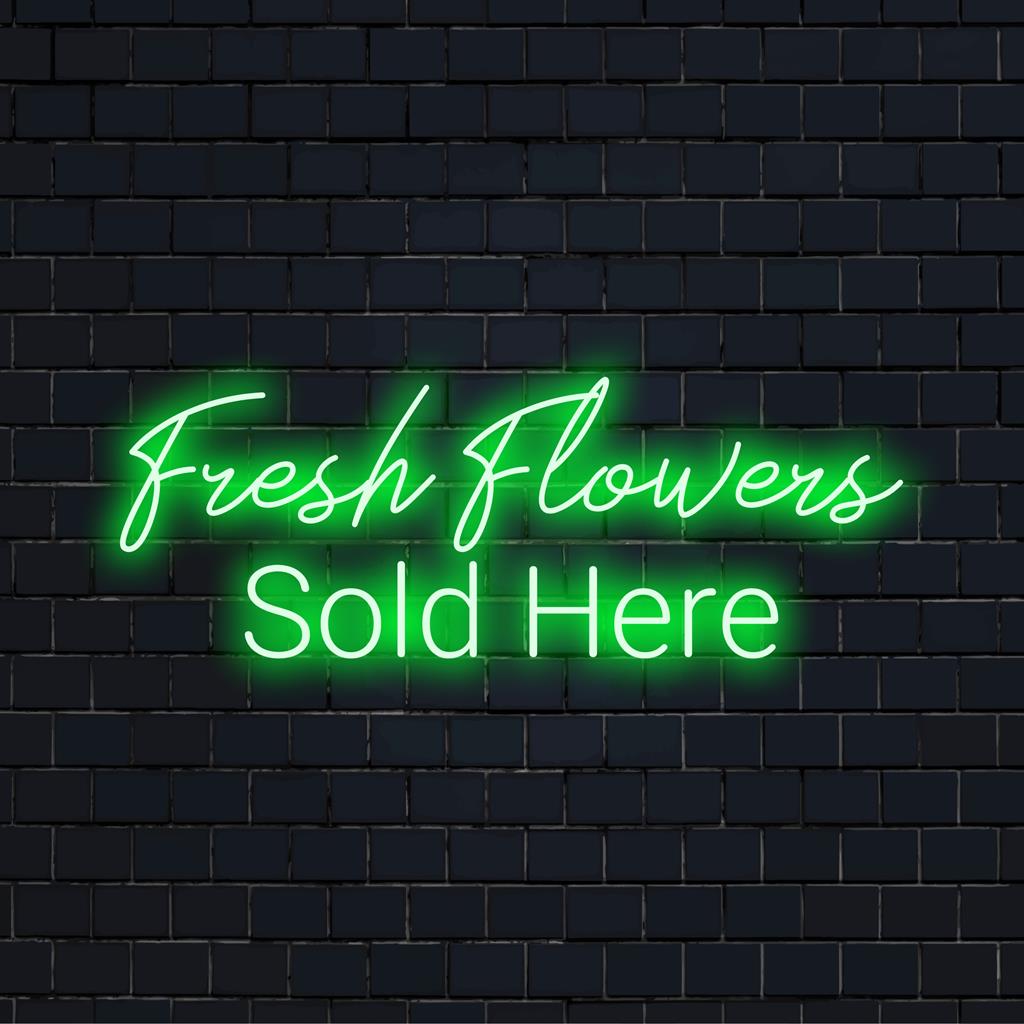 Tässä valoisassa ja kutsuvassa mittatilaustyönä tehdyssä LED-valokyltissä lukee "Tuoreita kukkia myydään täällä".