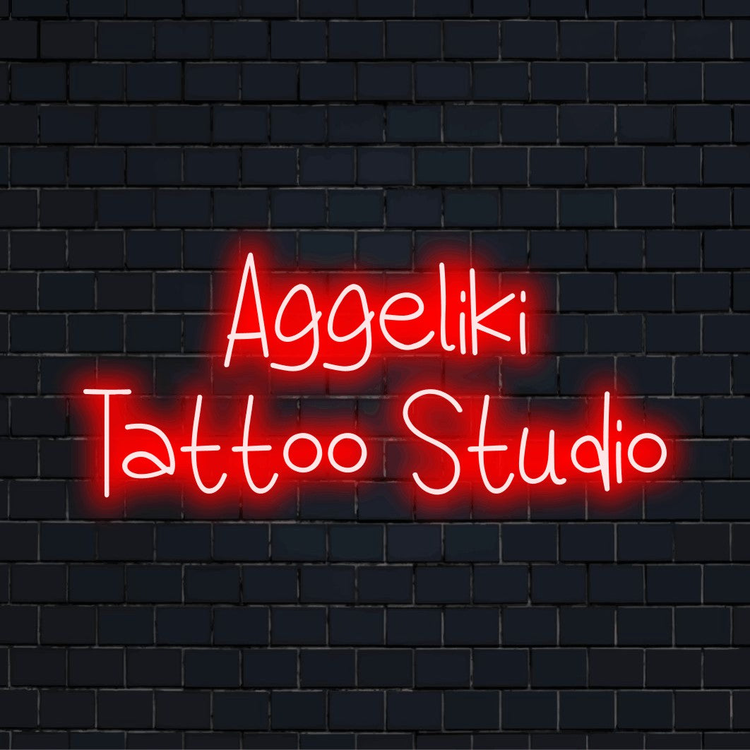 Aggeliki Tattoo Studio Personalized Neon Light with glowing neon text on black brick background
