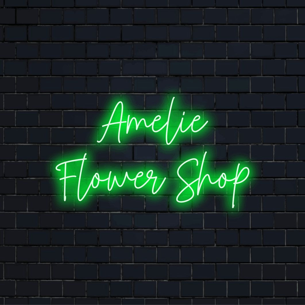 Amelie Flower Shop Personalized Neon Light with bright neon glow on dark brick background