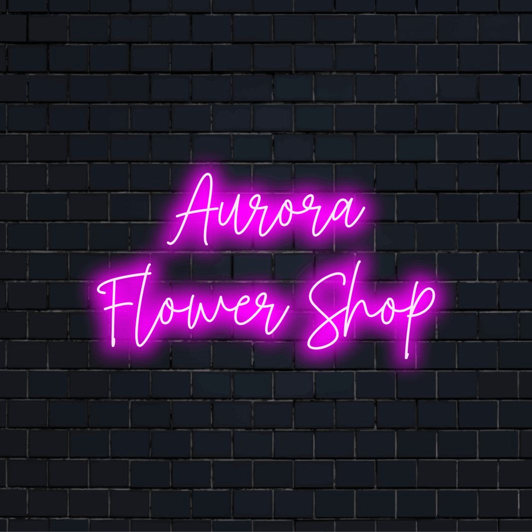 Aurora Flower Shop Personalized LED Neon Sign, glowing lettering against brick backdrop