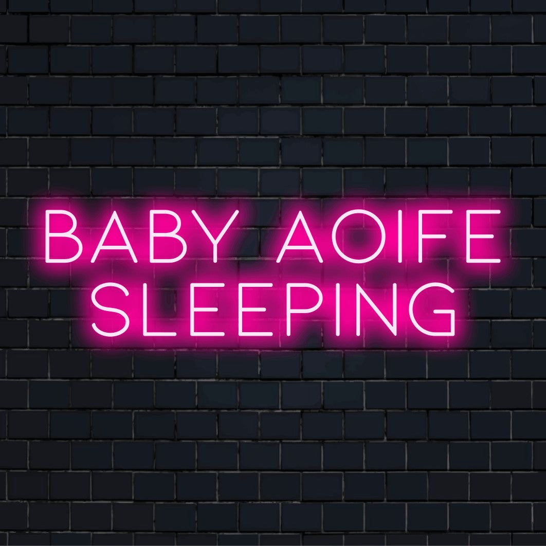 Baby Aoife Sleeping Custom Name Neon Sign, neon text light on black brick background