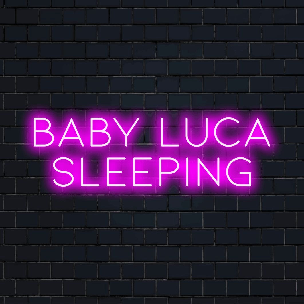 Baby Luca Sleeping Personalized LED Neon Sign, bright LED glow against black brick wall