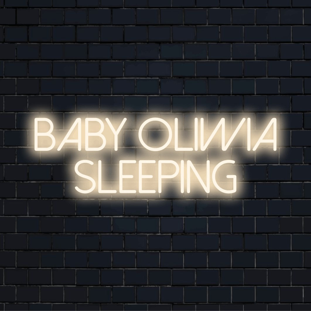 Baby Oliwia Sleeping Personalized LED Neon Sign, glowing neon text on dark brick background