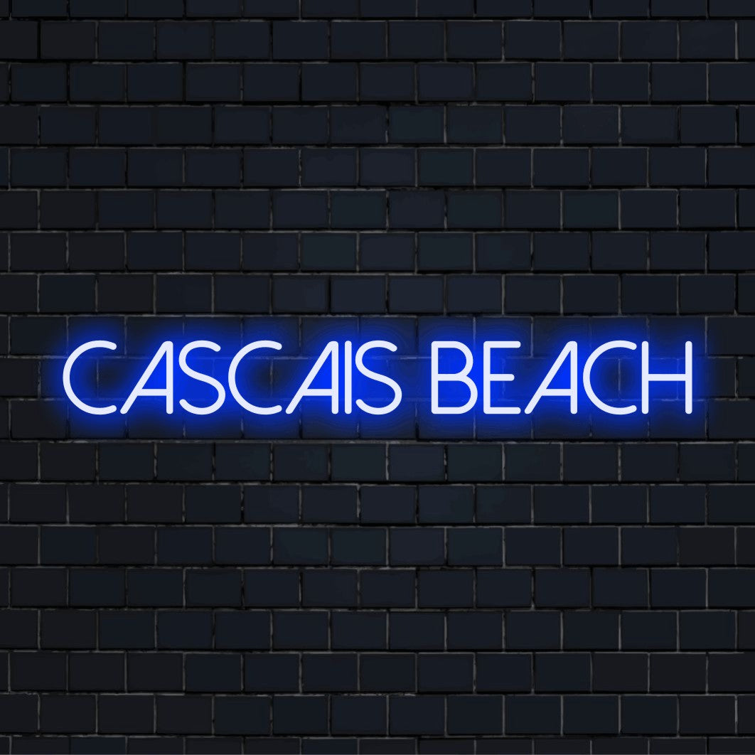 Cascais Beach Neon Sign, bright neon lettering against brick backdrop