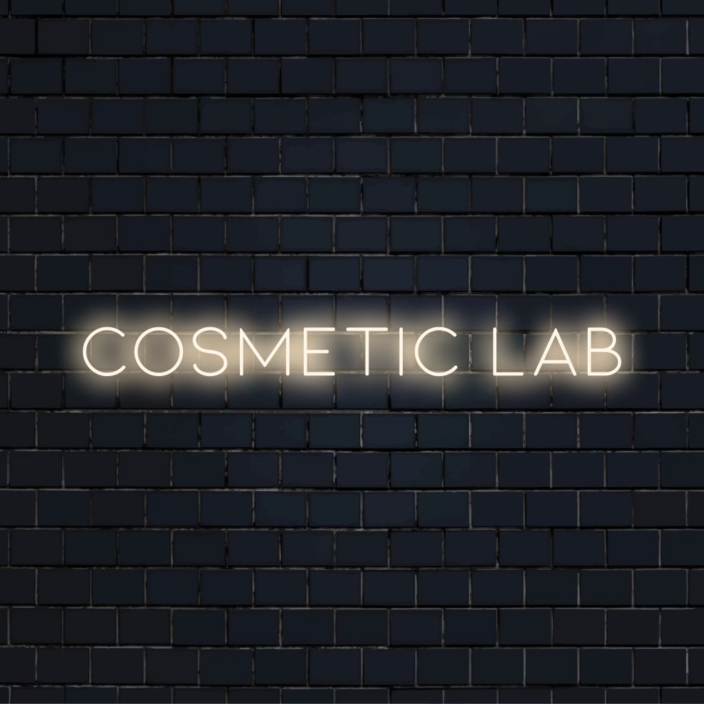Cosmetic Lab Neon Sign, glowing lettering on black brick background
