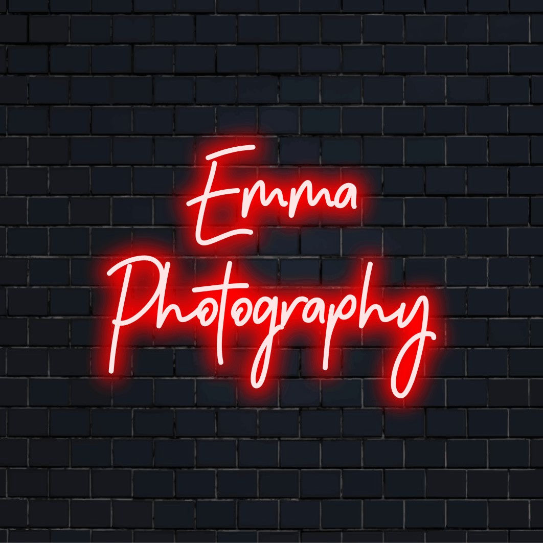 Emma Photography Custom Name Neon Sign, glowing lettering on dark brick background