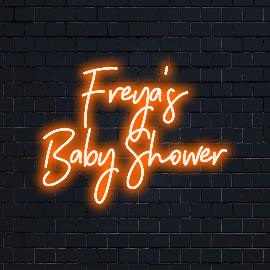 Freya_s Baby Shower Custom Name Neon Sign, bright neon glow on dark brick background