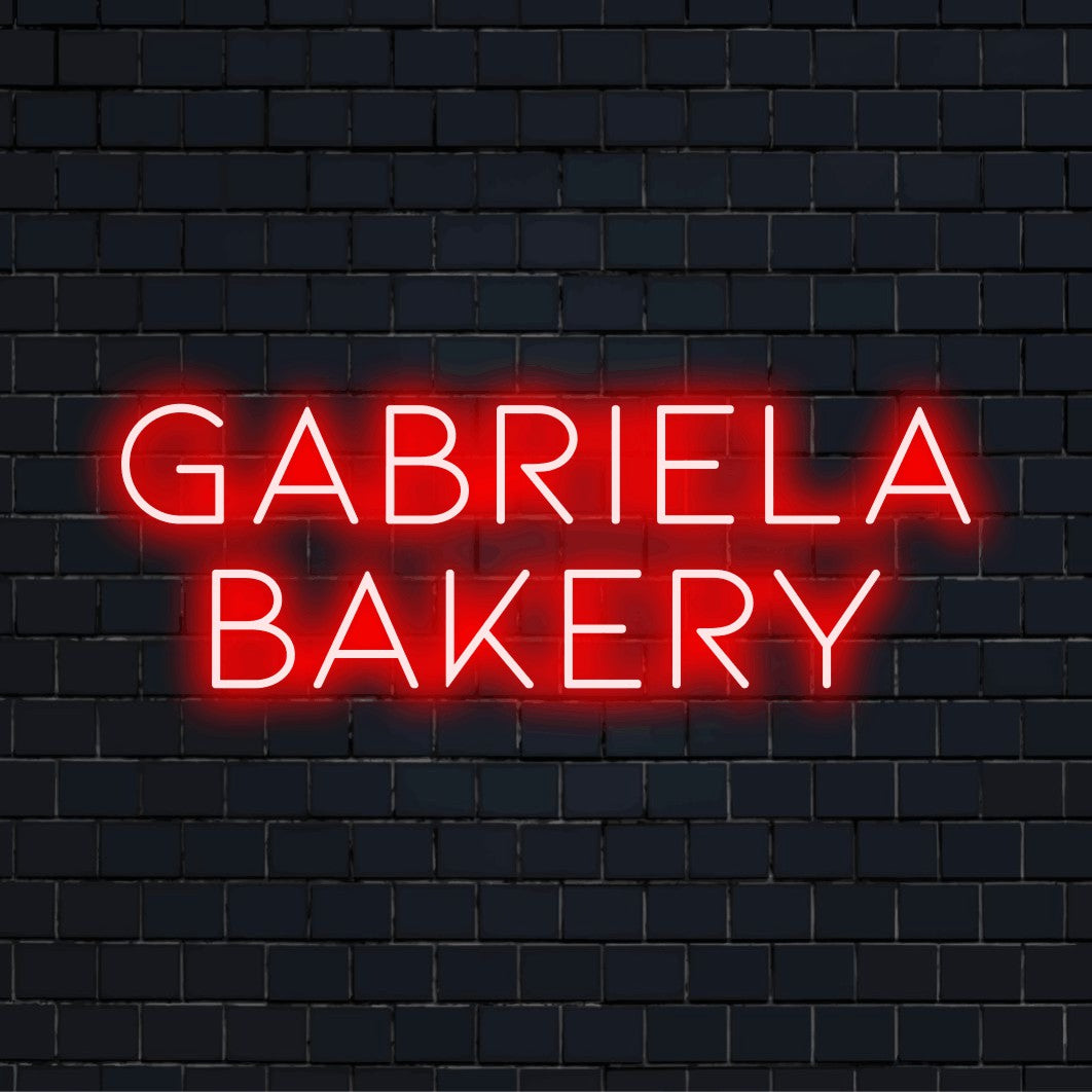 Gabriela Bakery Personalized LED Neon Sign, bright LED glow against black brick wall
