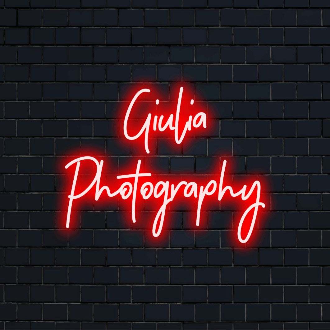 Giulia Photography Personalized Neon Light with bright neon lettering on black brick background