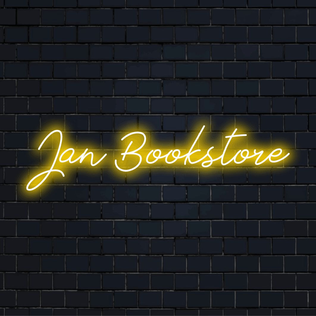 Jan Bookstore Custom Name Neon Sign, glowing lettering on dark brick background