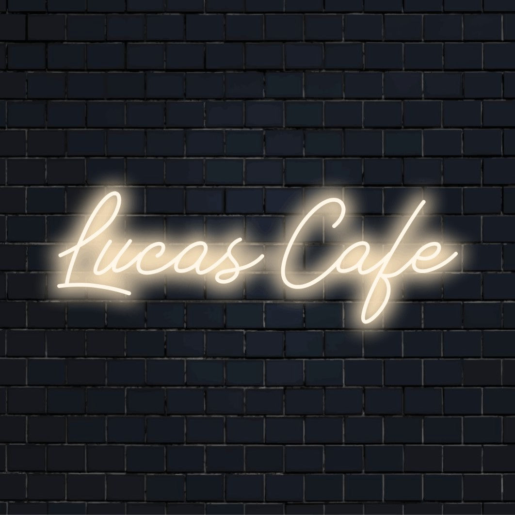 Lucas Cafe Custom Name Neon Sign, bright LED glow on dark brick background