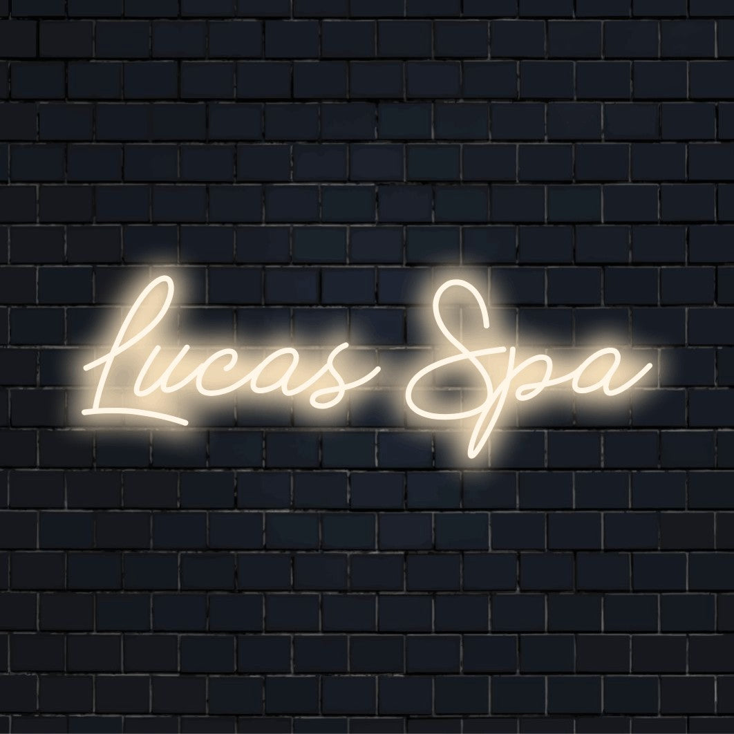 Lucas Spa Personalized LED Neon Sign, bright neon glow on dark brick background