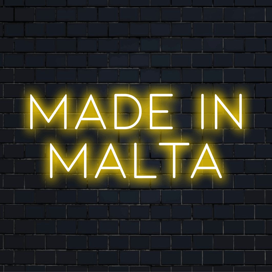 Made In Malta Neon Light with soft neon glow against brick backdrop