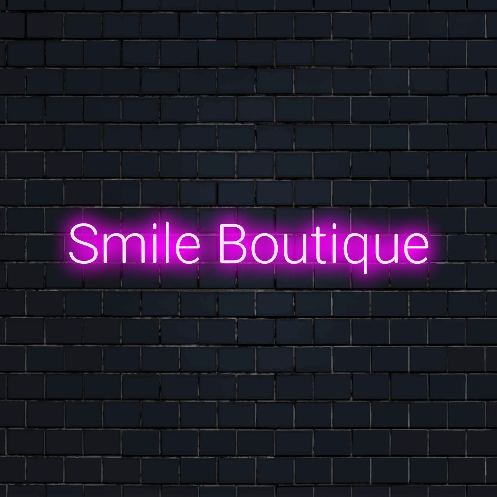 Smile Boutique Neon Light with glowing wall decor on dark brick background