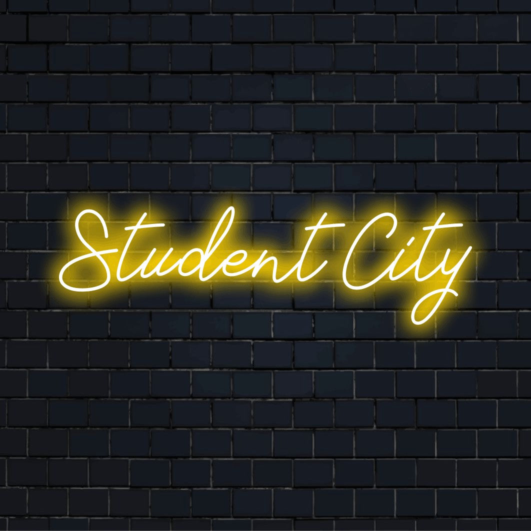 Student City Neon Sign, glowing wall decor against brick backdrop