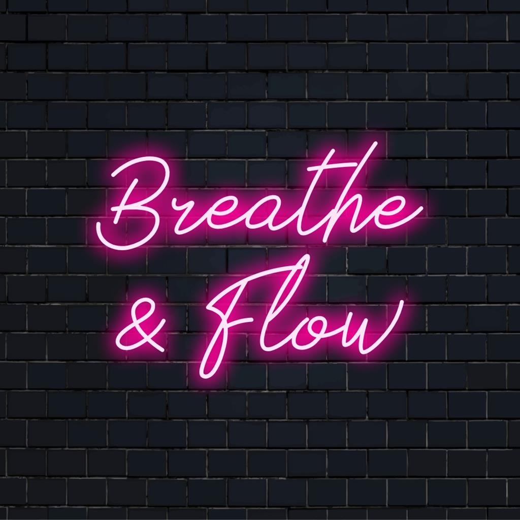 LED neon sign with the words Breathe And Flow, a calming and stylish wall decor for mindfulness spaces.