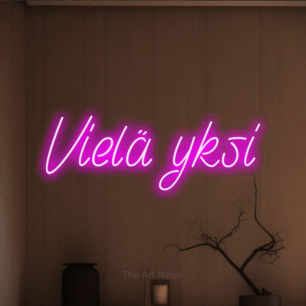 LED neon sign reading “Vielä yksi”, arranged in a single line.