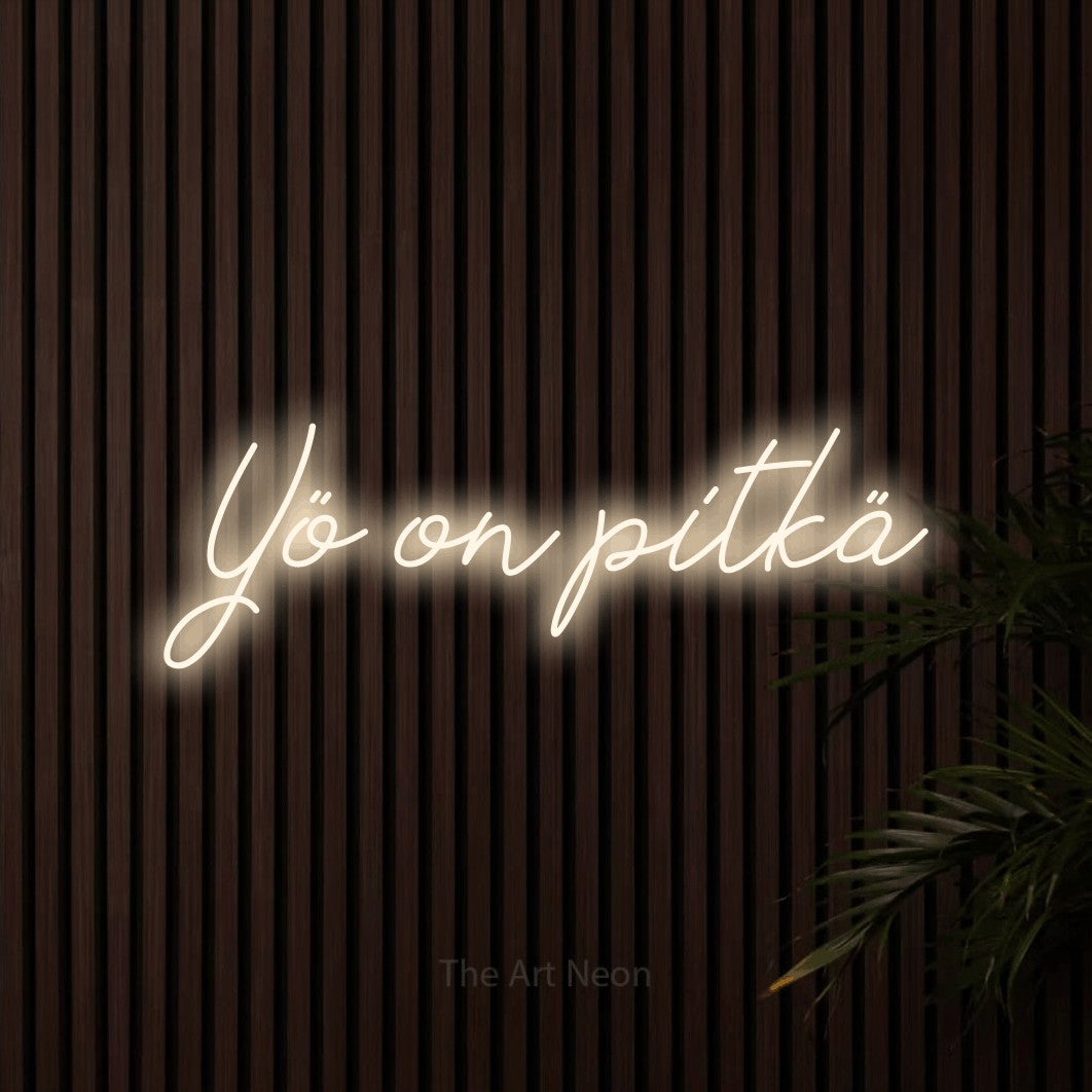 LED neon sign reading “Yö on pitkä”, arranged in a single line.