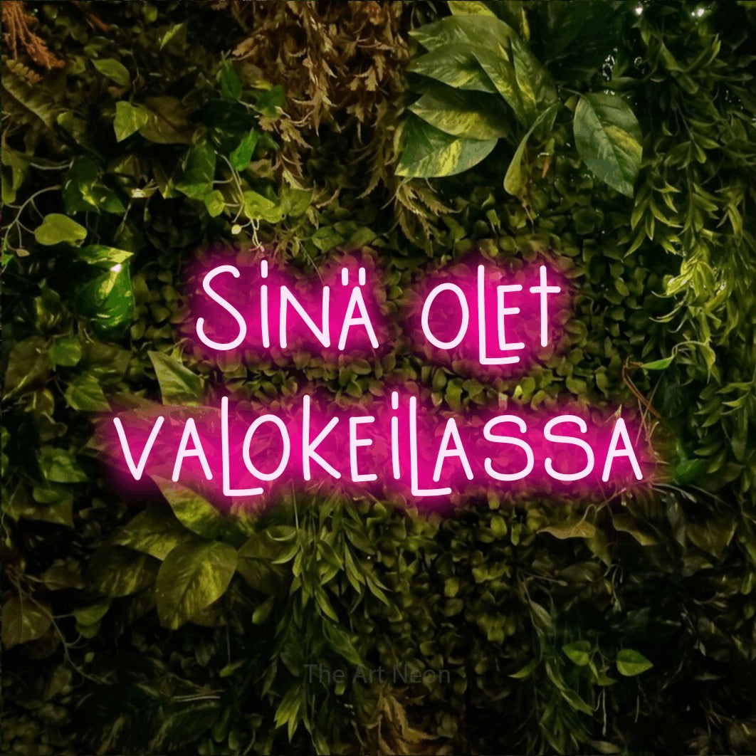LED neon sign reading “Sinä olet valokeilassa”, arranged in 2 lines.