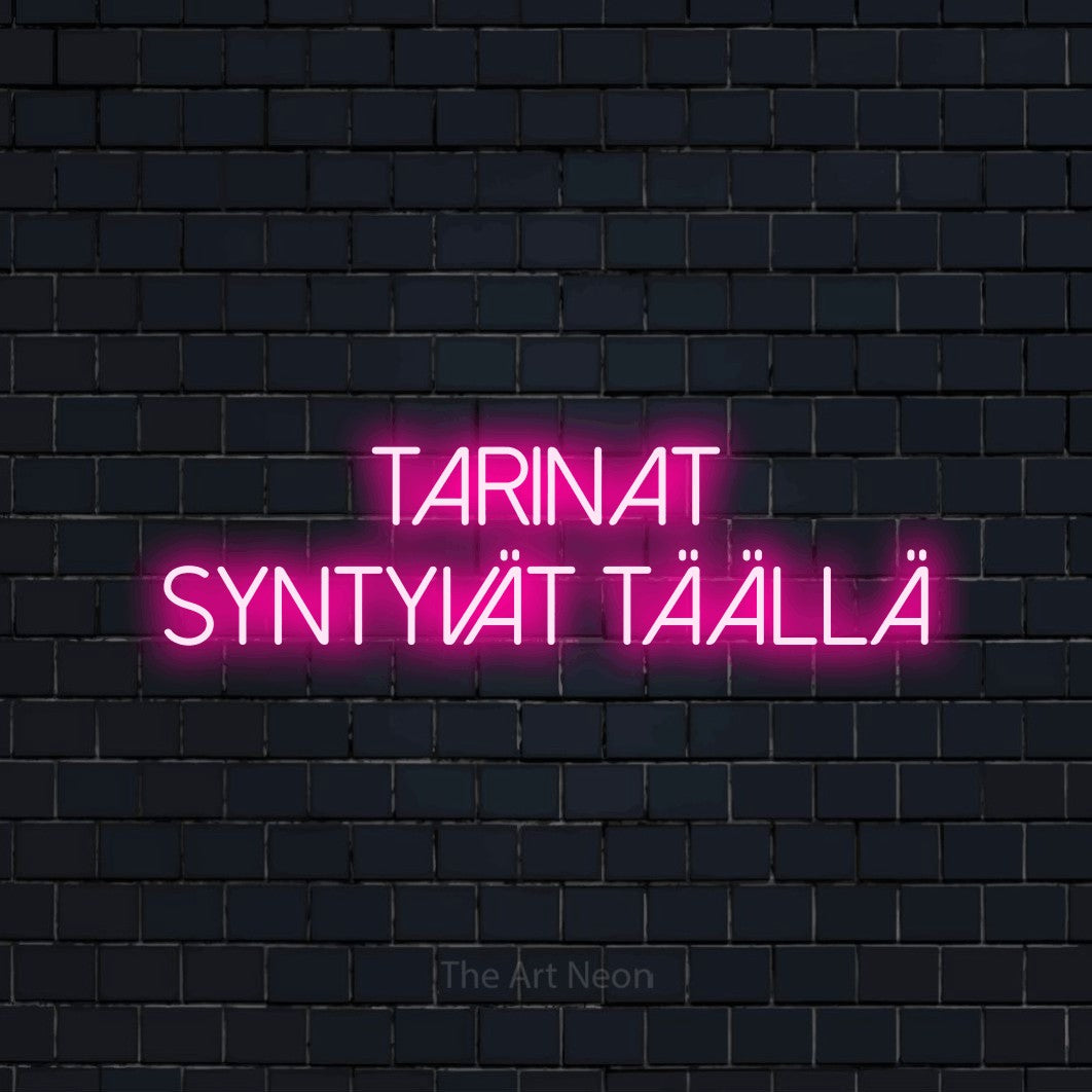 LED neon sign reading “tarinat syntyvät täällä”, arranged in 2 lines.