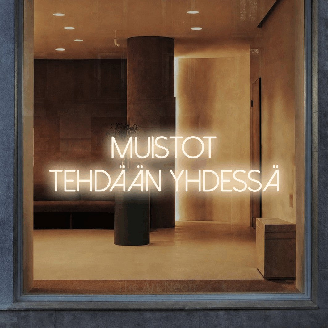 LED neon sign reading “Muistot tehdään yhdessä”, arranged in 2 lines.