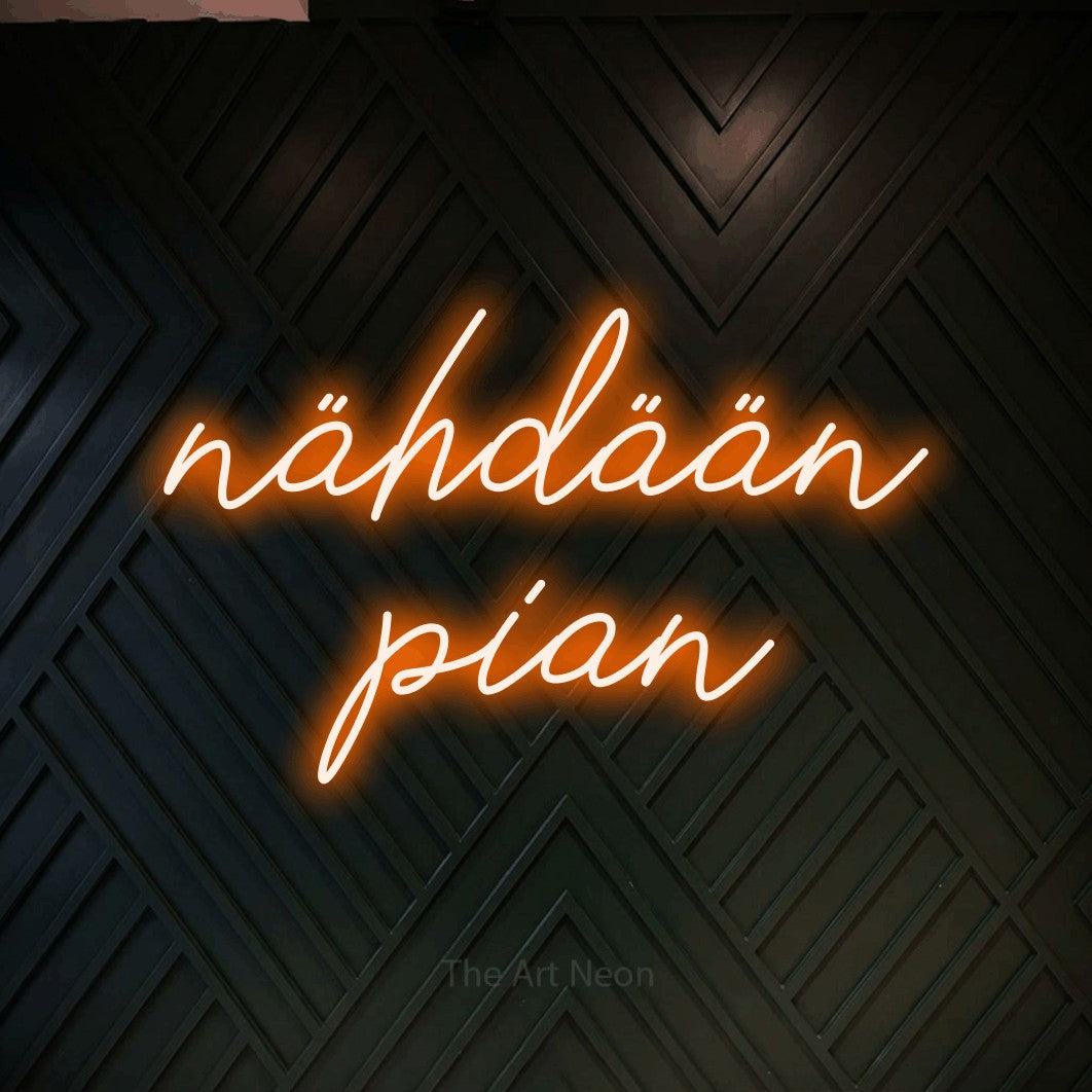 LED neon sign reading “nähdään pian”, arranged in 2 lines.