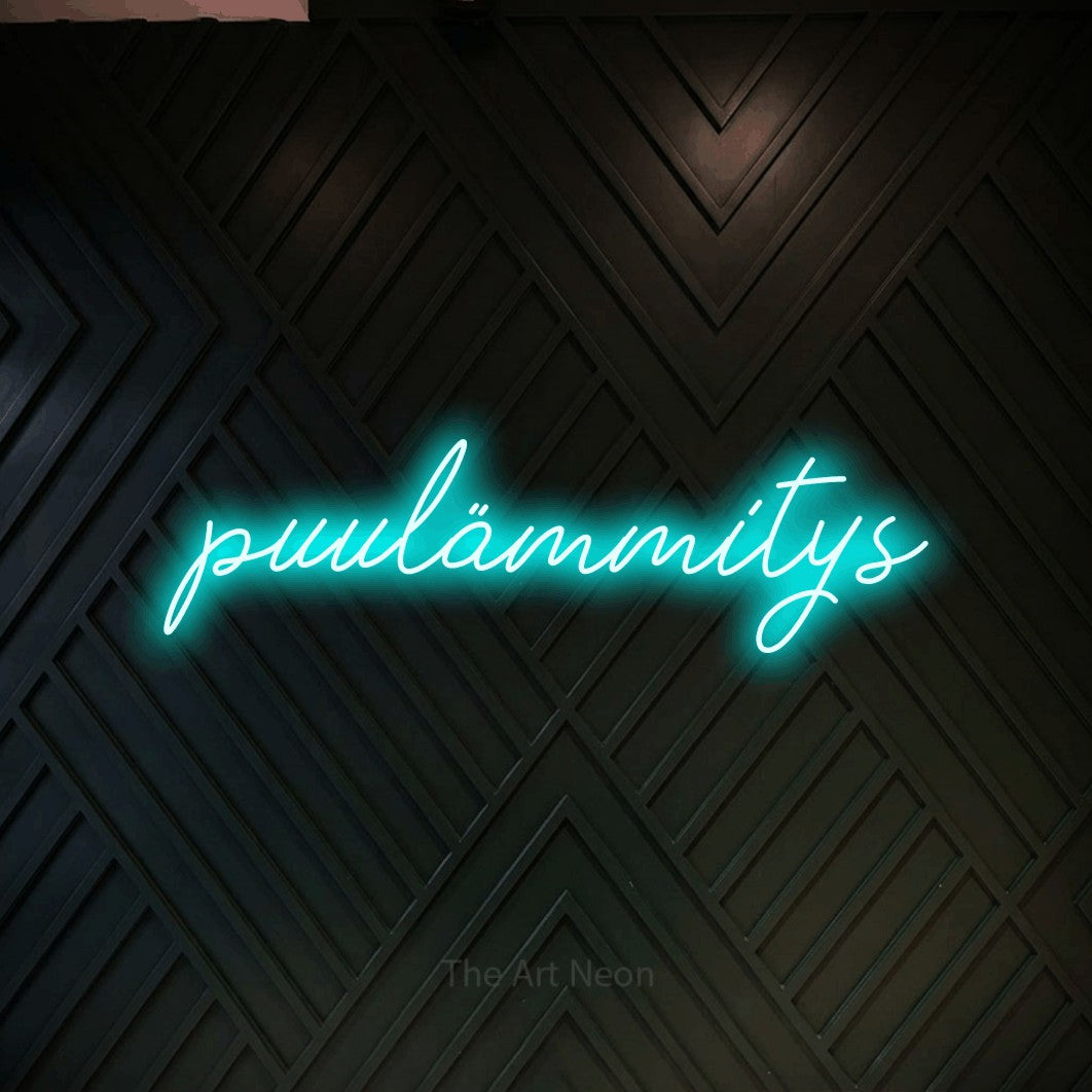 LED neon sign reading “puulämmitys”, arranged in a single line.