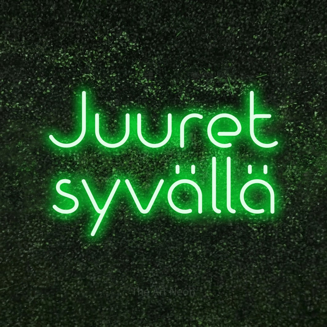 LED neon sign reading “Juuret syvällä”, arranged in 2 lines.