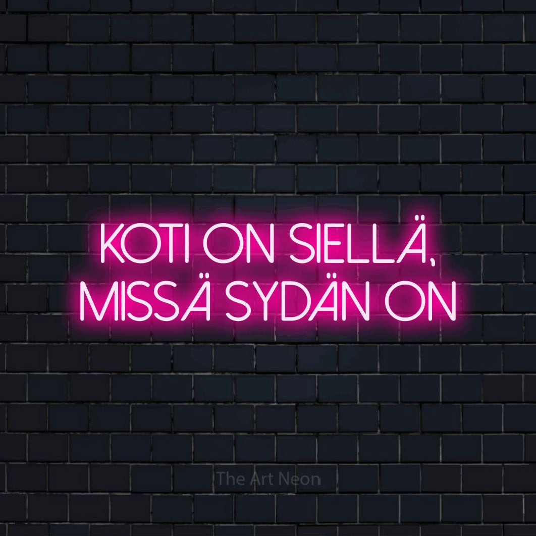 LED neon sign reading “koti on siellä, missä sydän on”, arranged in 2 lines.