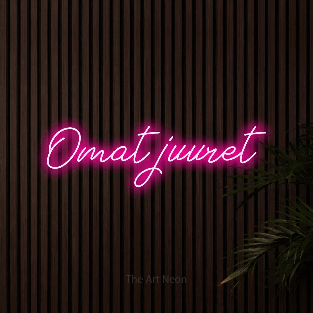 LED neon sign reading “Omat juuret”, arranged in a single line.
