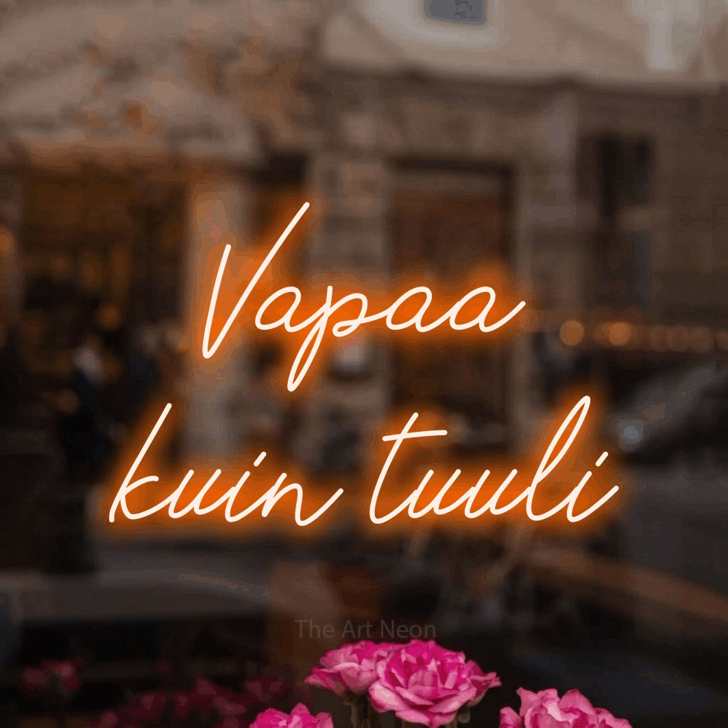 LED neon sign reading “Vapaa kuin tuuli”, arranged in 2 lines.