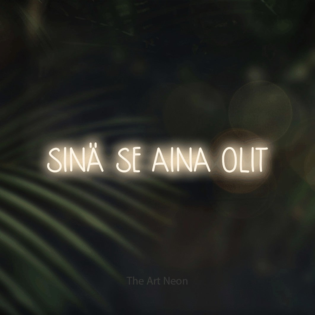LED neon sign reading “SINÄ SE AINA OLIT”, arranged in a single line.