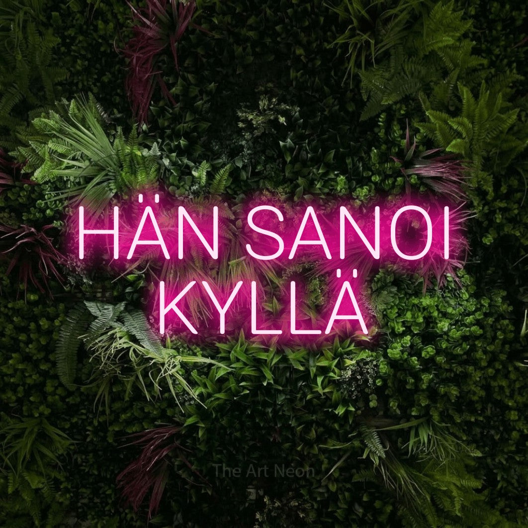 LED neon sign reading “HÄN SANOI KYLLÄ”, arranged in 2 lines.