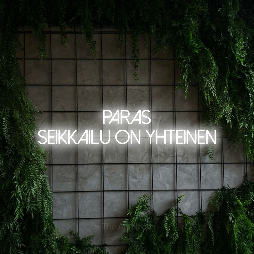 LED neon sign reading “Paras seikkailu on yhteinen”, arranged in 2 lines.