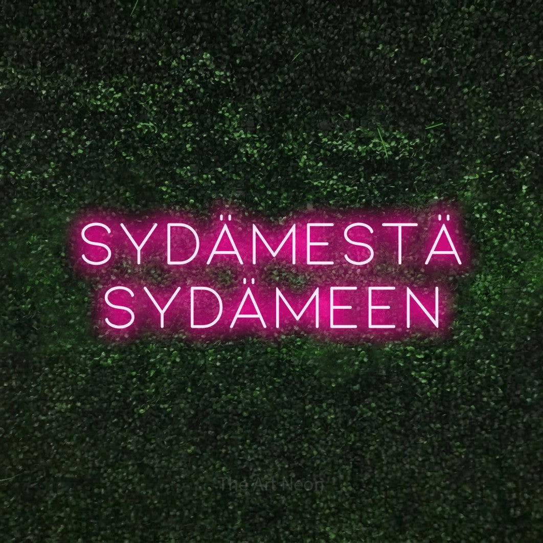 LED neon sign reading “sydämestä sydämeen”, arranged in 2 lines.