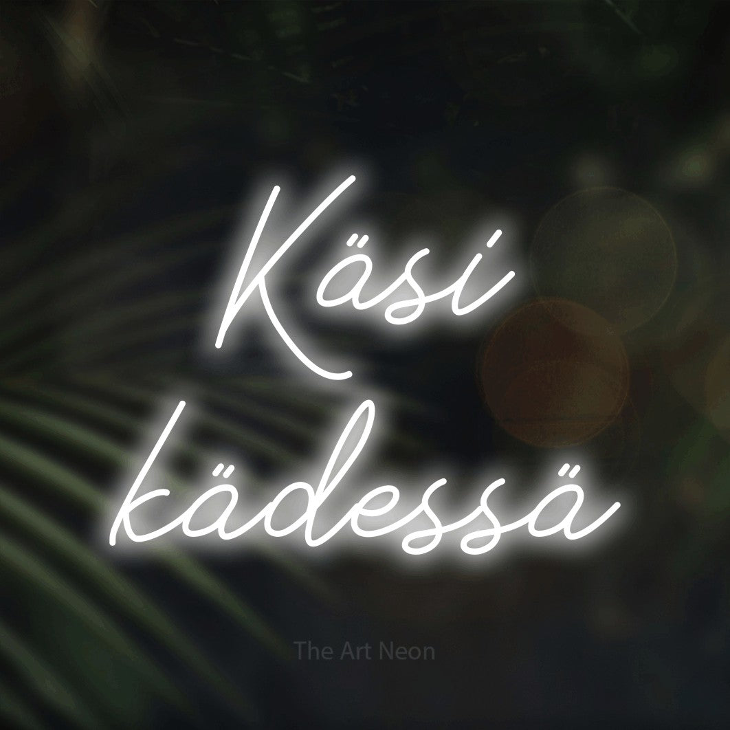LED neon sign reading “Käsi kädessä”, arranged in 2 lines.