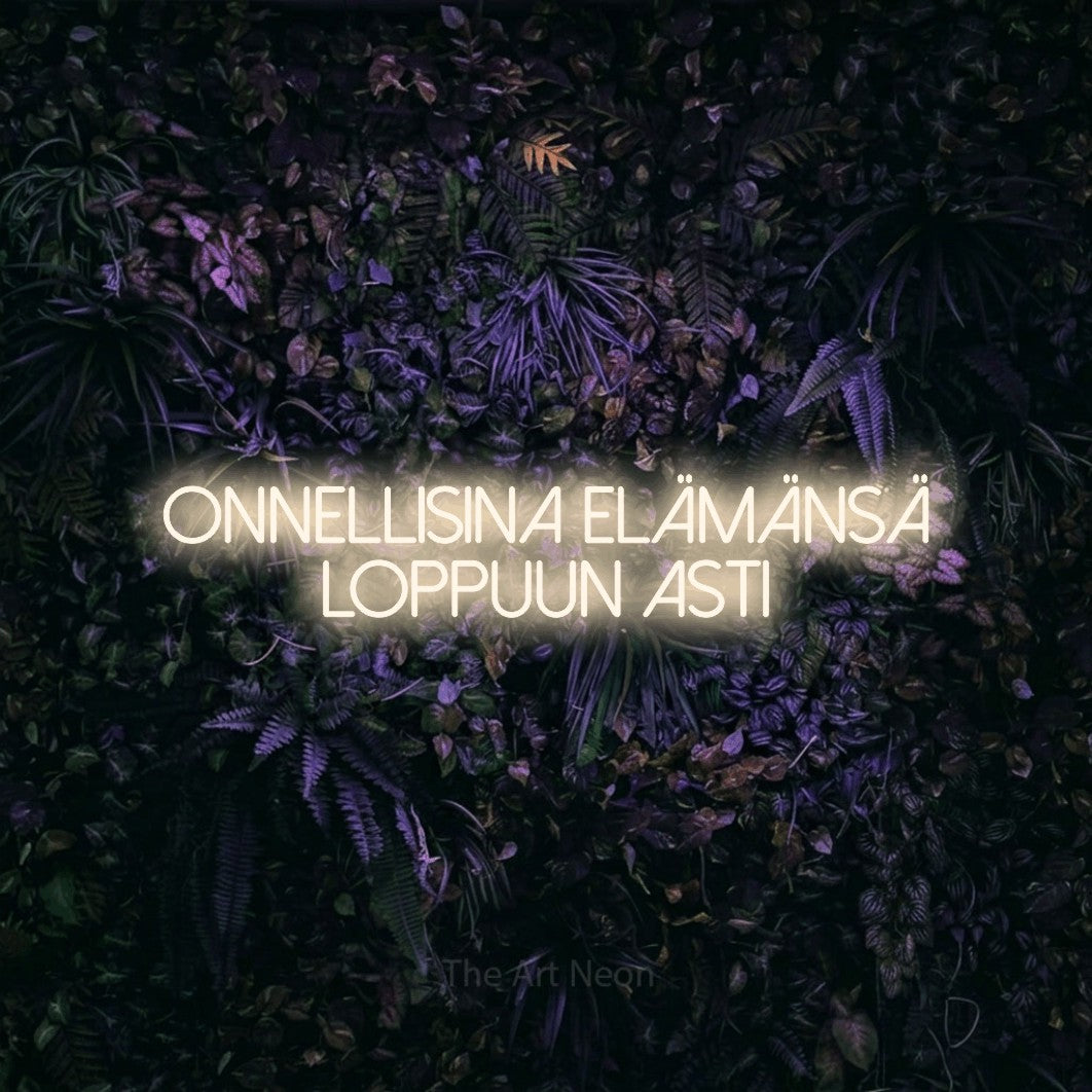 LED neon sign reading “Onnellisina elämänsä loppuun asti”, arranged in 2 lines.