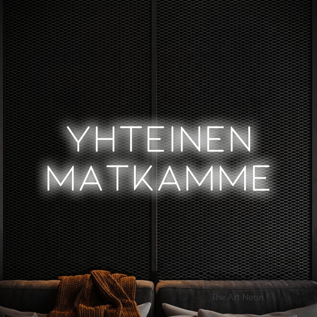 LED neon sign reading “Yhteinen matkamme”, arranged in 2 lines.