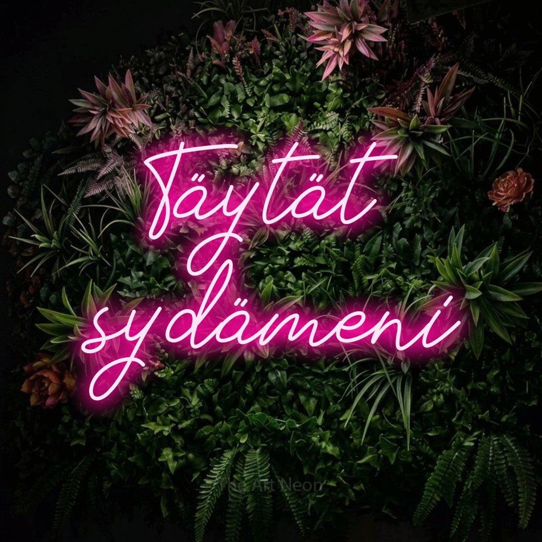 LED neon sign reading “Täytät sydämeni”, arranged in 2 lines.