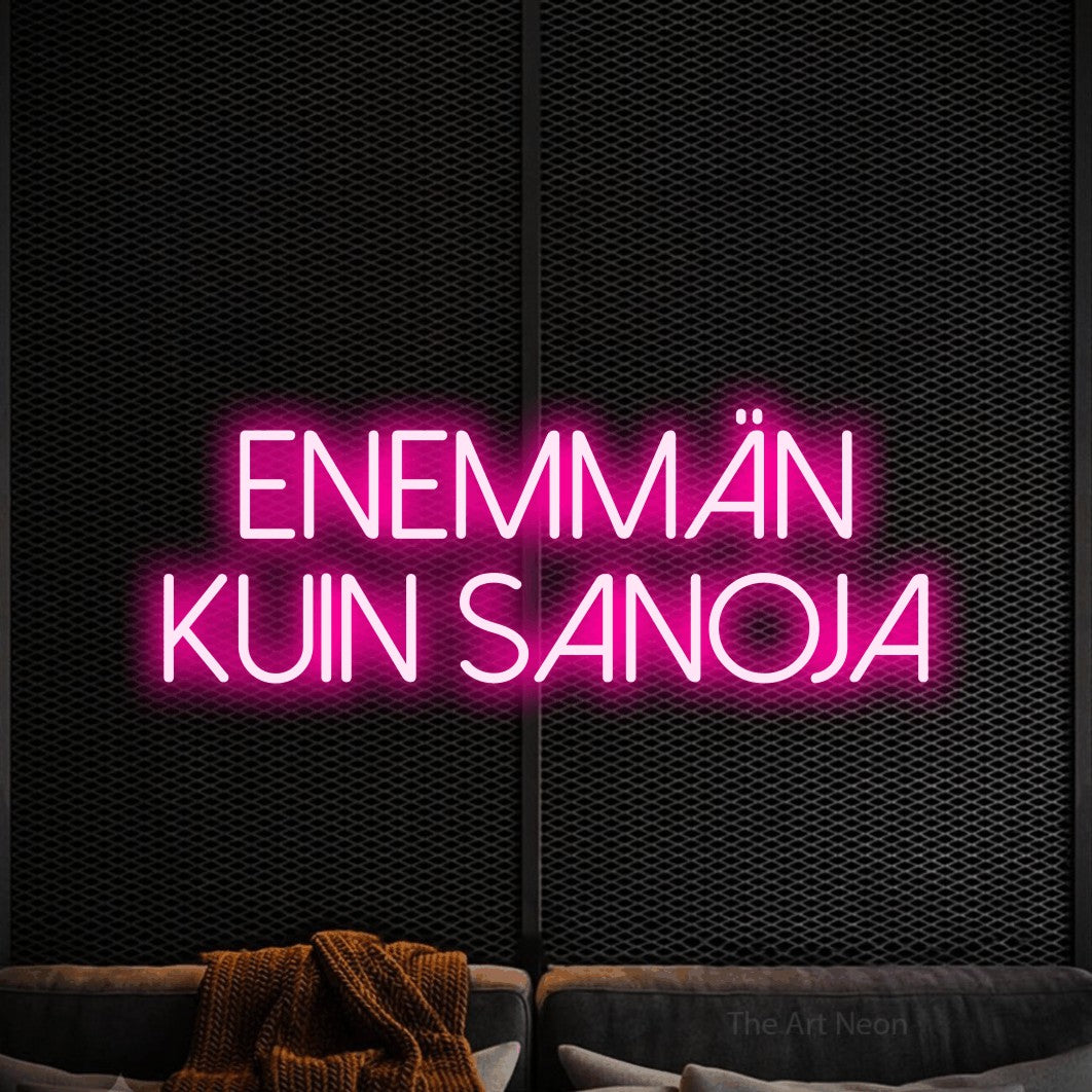 LED neon sign reading “ENEMMÄN KUIN SANOJA”, arranged in 2 lines.