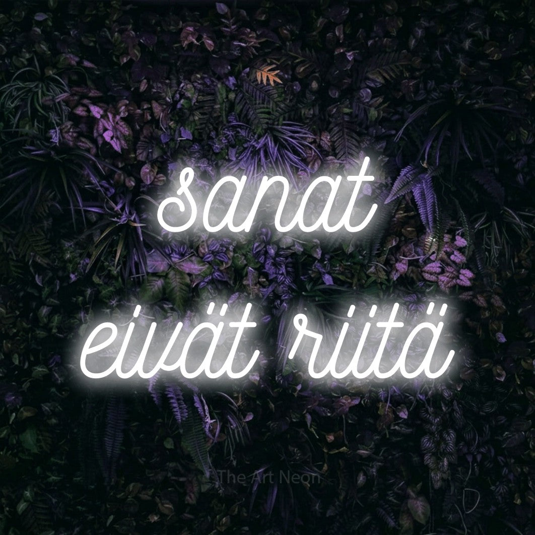 LED neon sign reading “sanat eivät riitä”, arranged in 2 lines.