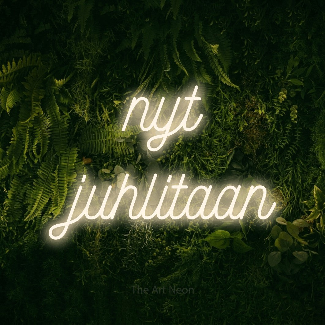 LED neon sign reading “nyt juhlitaan”, arranged in 2 lines.