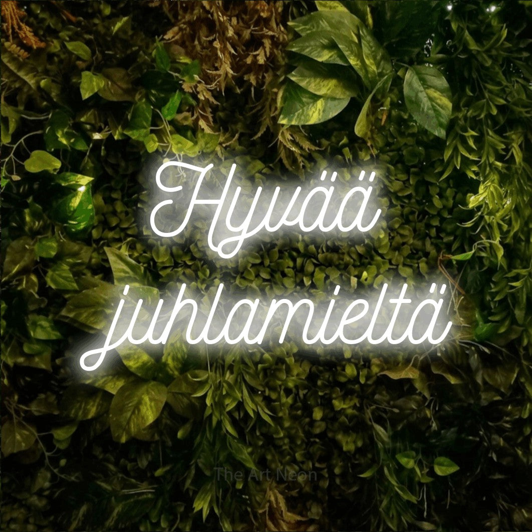 LED neon sign reading “Hyvää juhlamieltä”, arranged in 2 lines.