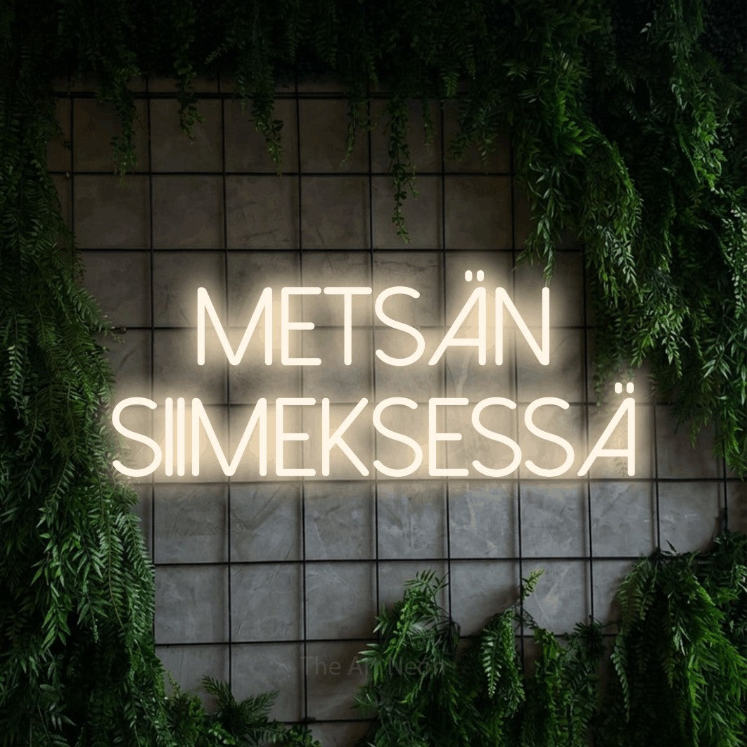LED neon sign reading “metsän SIIMEKSESSÄ”, arranged in 2 lines.