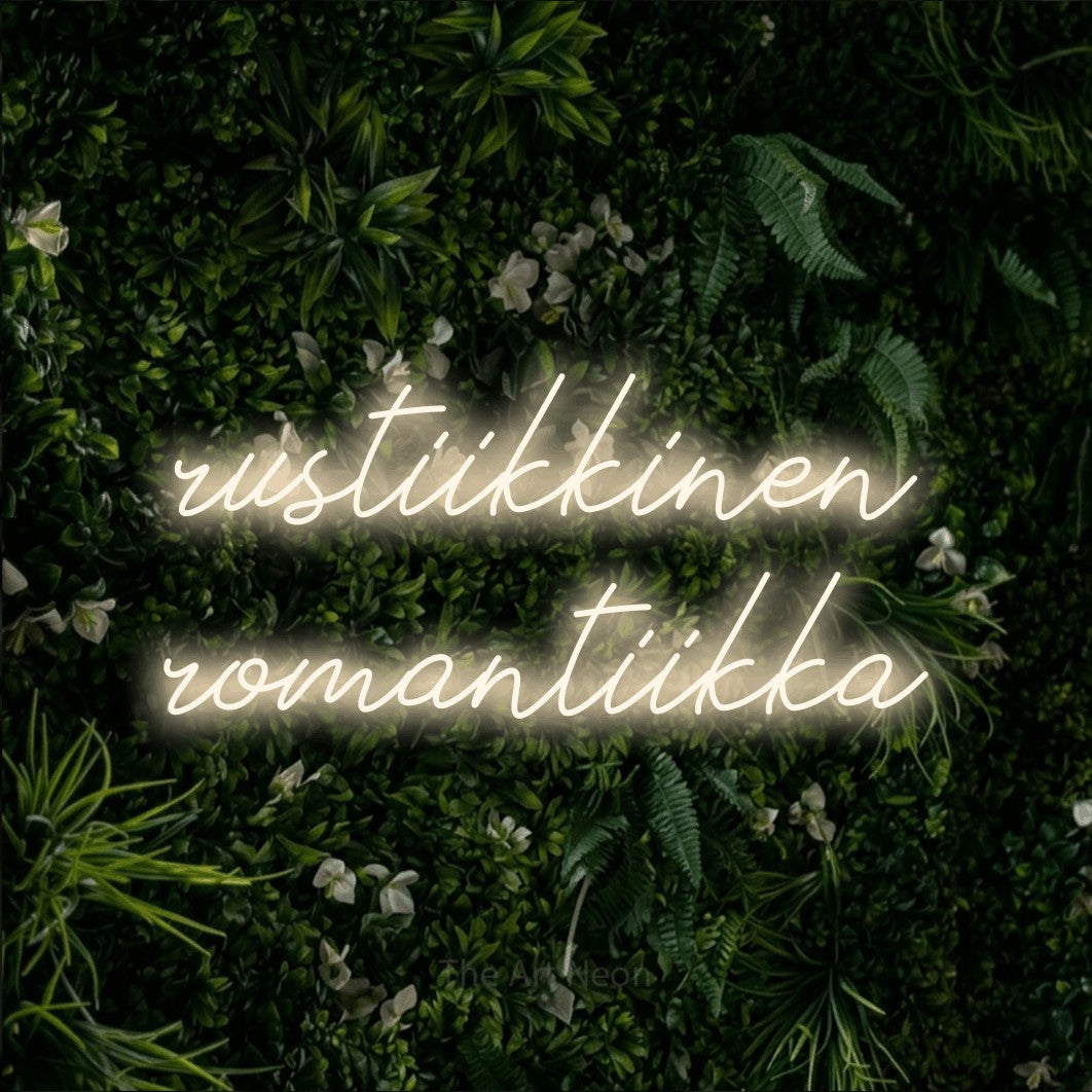 LED neon sign reading “rustiikkinen romantiikka”, arranged in 2 lines.