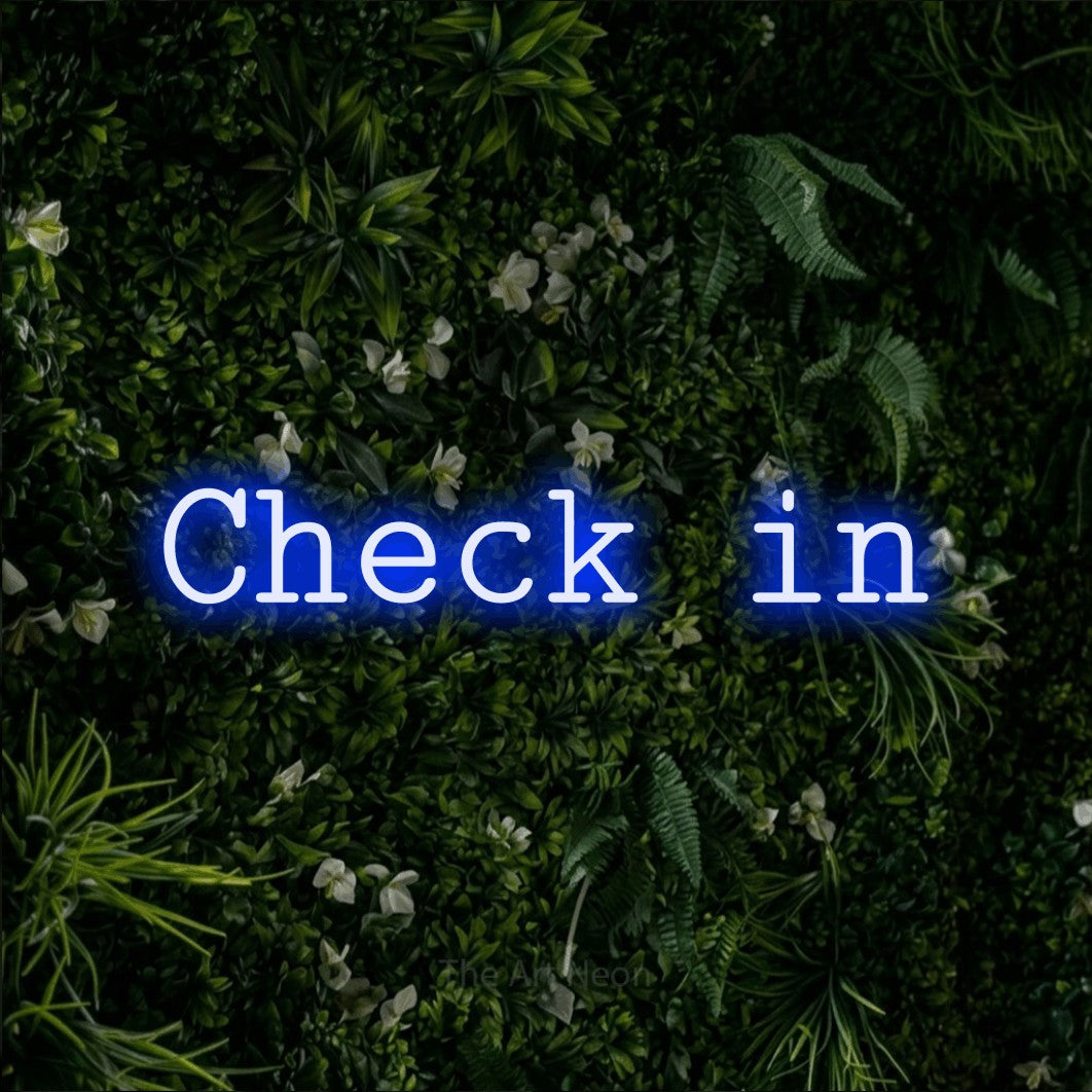 LED neon sign reading “Check in”, arranged in a single line.