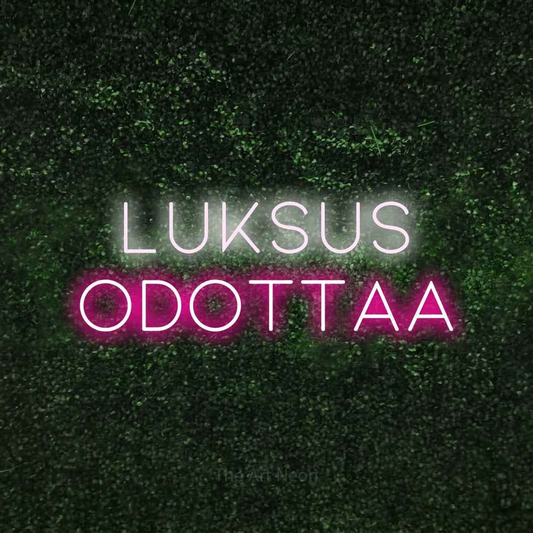 LED neon sign reading “Luksus odottaa”, arranged in 2 lines.