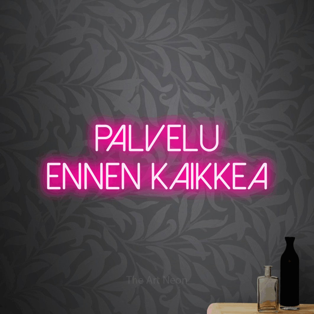 LED neon sign reading “Palvelu ennen kaikkea”, arranged in 2 lines.