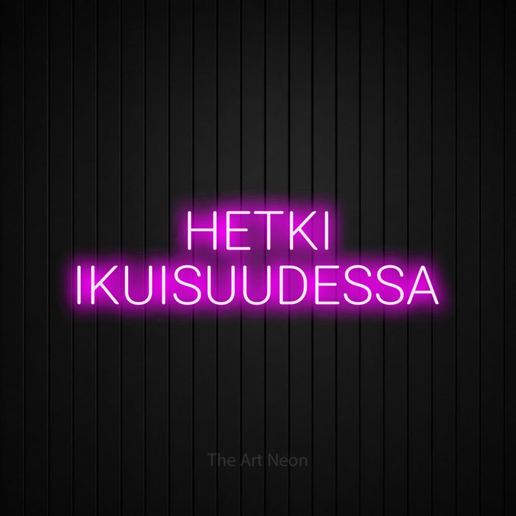 LED neon sign reading “HETKI IKUISUUDESSA”, arranged in 2 lines.